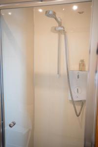 a shower in a bathroom with a toilet at The Shepherds Inn in Penrith