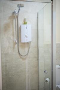 a shower in a bathroom with a glass shower stall at The Shepherds Inn in Penrith