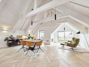 a white living room with a table and chairs at Shoreline - Emsworth in Emsworth