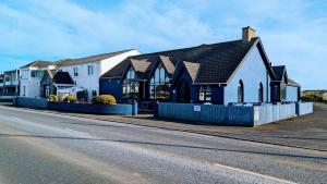 a building on the side of a road with a street at Inn On The Coast in Portrush