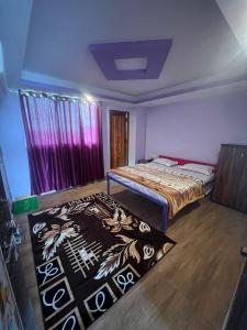 a bedroom with a bed and a rug on the floor at Roshan Resorts in Bhopal