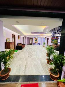 a large room with potted plants on the floor at Roshan Resorts in Bhopal