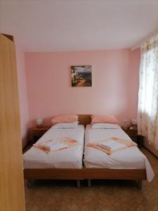 two beds in a small room with aermottermottermottermott at Guesthouse Olimp in Sozopol