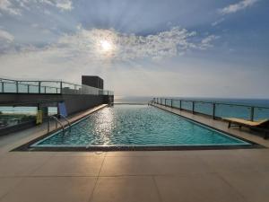 a swimming pool on the roof of a building at Ocean Breeze Aparthotel Negombo R11 B01 in Negombo