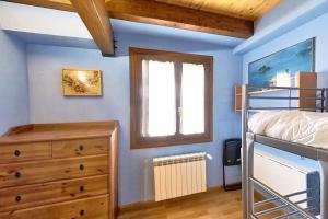 a bedroom with a bunk bed and a wooden dresser at Casa Ligües - tucasaenlospirineos in Escarrilla