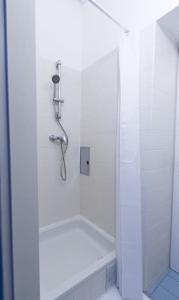 baño blanco con ducha y puerta de cristal en josef's home I Studio near City Center, en Viena