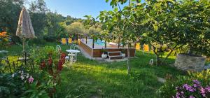 a garden with a pool and a table and chairs at La casetta di Eve Casa Vacanze in Guardialfiera