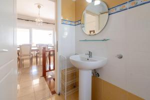a bathroom with a sink and a mirror and a table at Casa Del Mar in Neos Marmaras