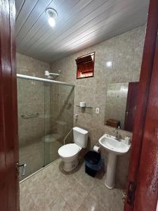 a bathroom with a shower and a toilet and a sink at Apt quarto 228 - hotel pedra Rodeadouro-Bonito-PE in Bonito