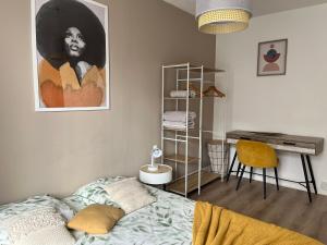 a bedroom with a bed and a desk and a painting at Good vibes Only apparts "So Zen" - 3 bedrooms - 8 pers - 20mn to Paris in Enghien-les-Bains