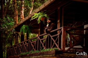a man standing on a fence on a bridge at Cotan Ecolodge in La Esperanza