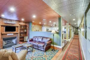 a living room with a couch and a fireplace at Smethport Vacation Rental with Fireplace and Lake View 