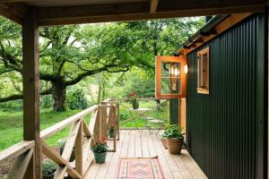 a wooden walkway leading to a house with plants on it at Shepherd's Rest Luxurious Hideaway in Glasgow