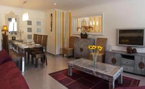 a living room with a table and a dining room at Con Encanto in Port de Soller