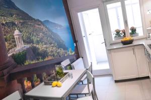 a kitchen with a table with a view of a mountain at Con Encanto in Port de Soller