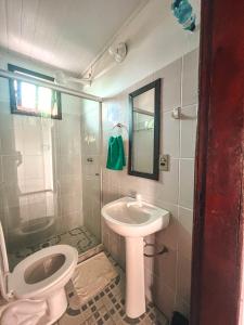 a bathroom with a toilet and a sink at Casa na Floresta in Itacaré +35 photos