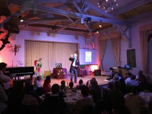 a man standing on a stage in front of a crowd at Le Moulin d'Andé in Andé