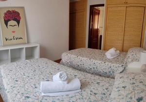 two beds in a hotel room with towels on them at Malaga, Calle Hermes in Málaga