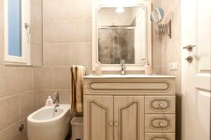 a bathroom with a sink and a toilet at Elegant comfy three-room apartment in Eur with parking in Rome