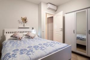 a bedroom with a bed with a blue and white comforter at Elegant comfy three-room apartment in Eur with parking in Rome
