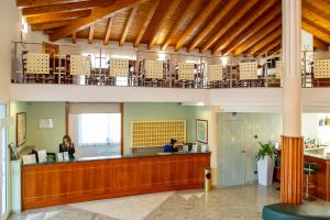 a lobby with a waiting area with people at a counter at Hotel Riz B.B in San Genesio ed Uniti