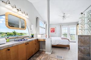 a bedroom with a bed and a sink and a bathroom at Luxe Farmhouse ~ Hot Tub + Pool ~ Great4Gatherings in Manor