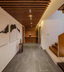 a hallway with stairs and paintings on the wall at Jiuhua Mountain Demaotang Hotel in Chizhou