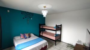 a bedroom with a bed and a bunk bed at Mandallah Hostel in Joinville