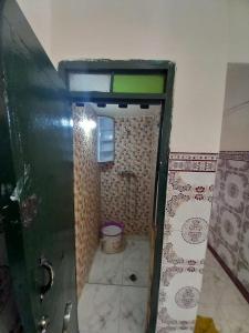 a small bathroom with a shower and a toilet at luxury apartment in Marrakesh