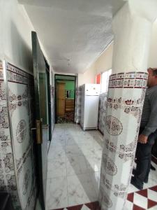 a man standing in a kitchen with a refrigerator at luxury apartment in Marrakesh