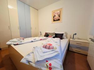 a bedroom with two beds with towels on them at Ani Apartments in Umag