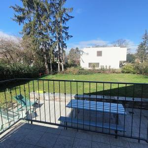 un banc assis à côté d'une clôture dans un parc dans l'établissement Maison de charme au cœur de Genève !, à Genève