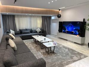 a living room with a couch and a big screen tv at ٍٍSaif in Cairo