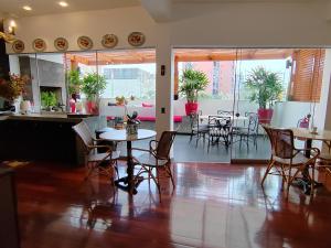 a dining room with tables and chairs in a room at Ana Frank Boutique Hotel in Lima