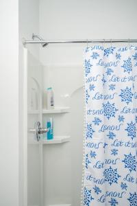 a bathroom with a shower curtain with blue snowflakes at Brand-new Parkview with Balcony in Old Fourth Ward 542Blvd203 in Atlanta