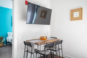 a dining room with a table and four chairs at Brand-new Parkview with Balcony in Old Fourth Ward 542Blvd203 in Atlanta