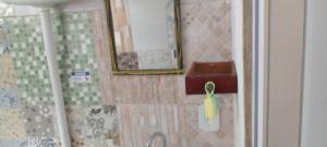 a bathroom with a mirror and a sink at GRUTA da Praia 2 in Saquarema +11 photos
