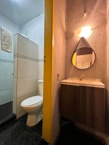 a bathroom with a toilet and a sink and a mirror at HMG - Praia de Botafogo in Rio de Janeiro