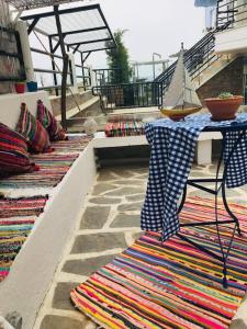 a row of colorful rugs sitting on a patio at Hara's House 2 in Gerakini