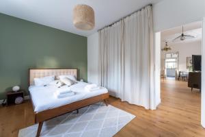 a bedroom with a bed and a living room at Apartament VinyLove - blisko Parku Zdrojowego i Term - by Space Apart in Jelenia Góra