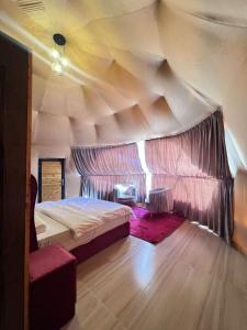a bedroom with a large bed in a tent at Wadi rum Ahmed Badawi in Wadi Rum