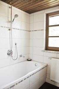 a white bathroom with a tub and a window at Ferienwohnung Kaim in Prichsenstadt