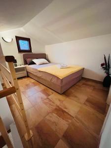 a small bedroom with a bed in a attic at Ani Apartments in Umag