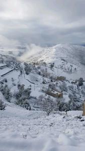 a snow covered hill with a building on it at كتامة ketama in Ketama