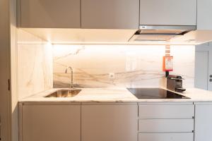 a kitchen with a sink and a counter top at Escadaria 21 Apartment by House and People in Braga