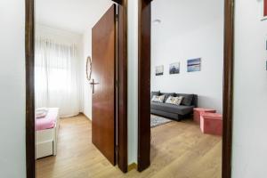 a door leading into a living room with a couch at Casino and Beach Apartment by House and People in Póvoa de Varzim