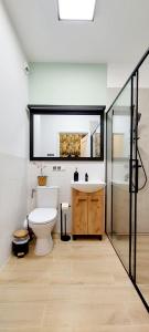 a bathroom with a toilet and a sink and a mirror at Panorama Garden in Olsztyn