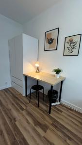 a desk with a lamp on it in a room at Warszawa Centrum Pokoje in Warsaw