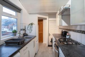 a kitchen with a sink and a stove at 3 Bed-Free Parking-Close to City in Low Team