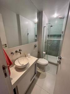 a bathroom with a sink and a toilet and a shower at Esplêndido e Aconchegante in Rio de Janeiro